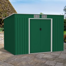 9x6 Lotus Hestia Pent Metal Shed with Foundation Kit in Dark Green - in situ, angle view, doors closed