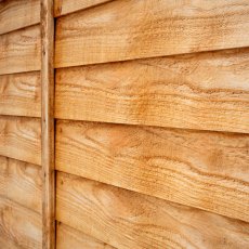 Side angle close-up of Forest Heritage lap fence panel highlighting overlapping timber slats.