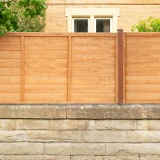 3ft high Forest Heritage lap fence panels installed on a low garden wall in a residential garden.