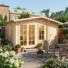 Three-quarter angle view of the Shire Bourne 14x8 wooden log cabin placed in a landscaped garden patio with patio furniture.