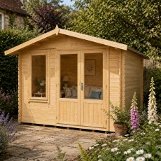 Shire Berryfield 11x6 log cabin with double doors and glass windows set in a landscaped garden patio