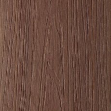 Close-up surface texture of Shire GigaShield composite decking in Nature light brown wood grain.