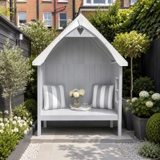Painted light grey Shire Rosewood garden arbour seat styled with cushions in a landscaped modern patio garden.