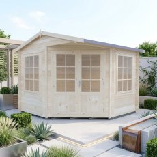 Shire Rochester corner log cabin in natural wood finish with glass windows on a paved garden patio