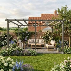 Shire 16x16 large wooden garden pergola with integrated decking floor and patio lounge furniture set on a lawn