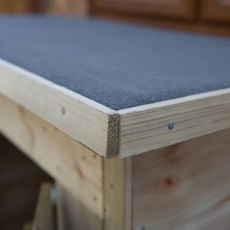 Close up of black mineral felt roof edge on pent garden storage unit