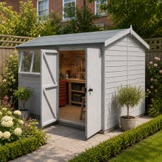 Shire Atlas 10x10 apex wooden garden shed painted sage green with cream trim, featuring double doors and side windows on a patio.