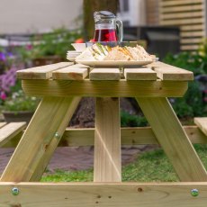 Rowlinson Traditional 6 Seater Picnic Table 1.5m - Pressure Treated - in situ, angle view, side
