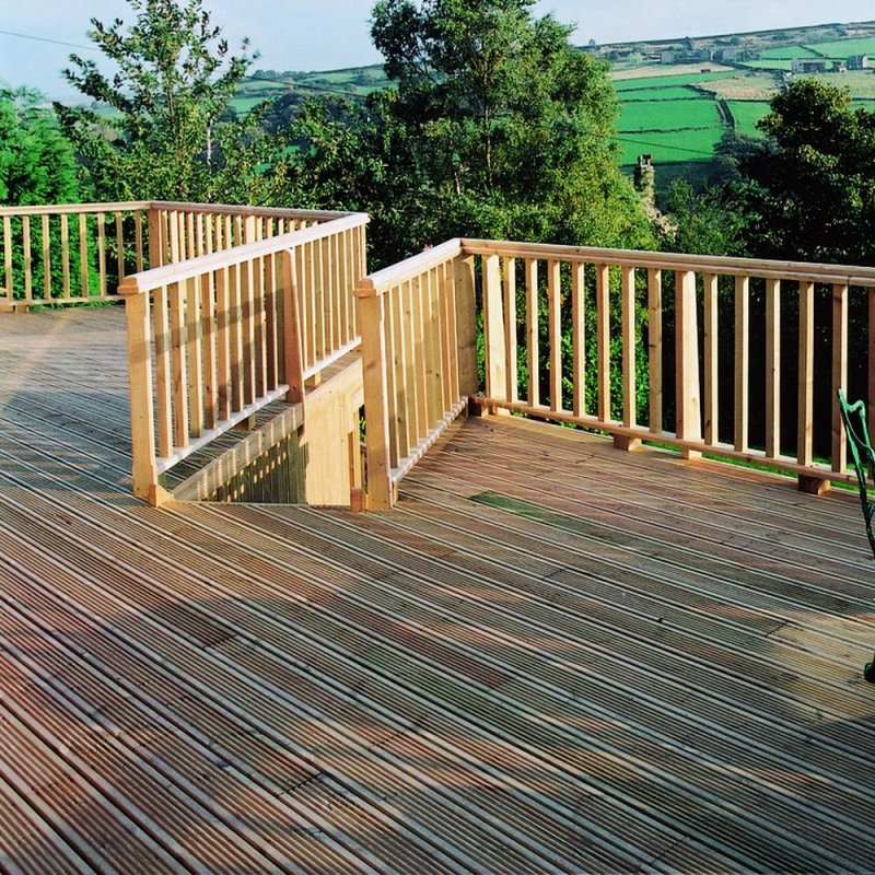 3.6m x 3.6m Shire wooden patio deck with balustrade handrails installed outdoors overlooking countryside
