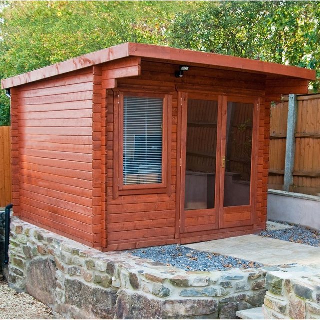 10Gx10 Shire Belgravia Log Cabin - insitu with doors and windows closesd and paiinted