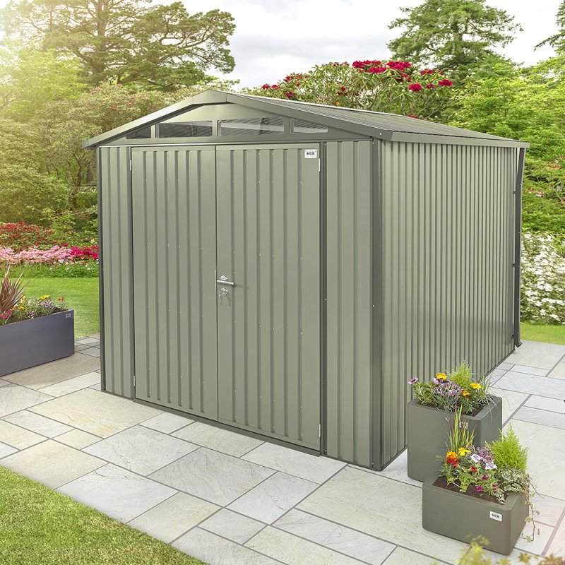 10x6 Hex Living Alton Apex Metal Shed in Sage Green - in situ, angle view, doors closed