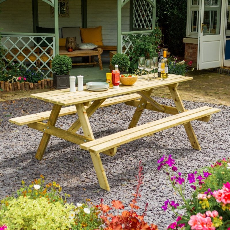 Rowlinson Traditional 8 Seater Picnic Table 1.8m - Pressure Treated - in situ, angle view